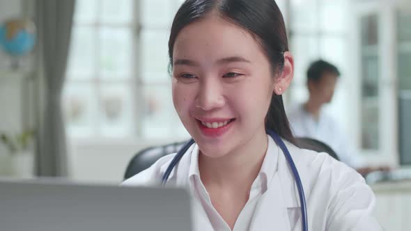 Close Up Young Asian Woman Doctor Is Using Laptop In Workplace. Medical Concept