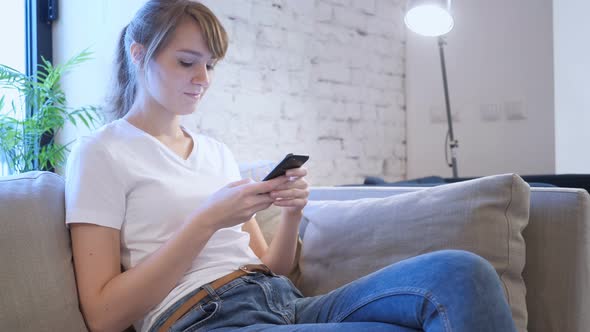 Casual Woman Using Smartphone in Creative Office