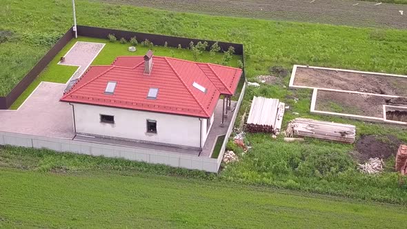 Aerial View of a Private House and a Yard with Fence Around