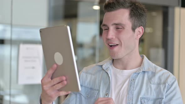 Portrait of Young Designer Doing Video Chat on Tablet