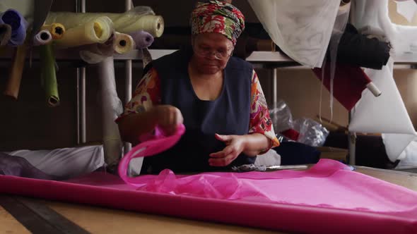 Mixed race woman working at a hat factory