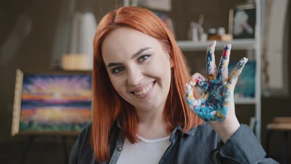 Redhaired Girl Talented Artist Female Painter Stands Posing in Art Studio Workshop Looking at Camera