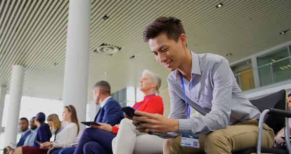 Asian Businessman using mobile phone in the business seminar 4k