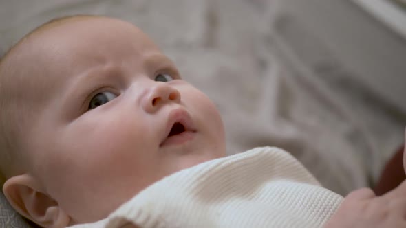 Baby Girl Lying on the Bed and with Her Dad Playing