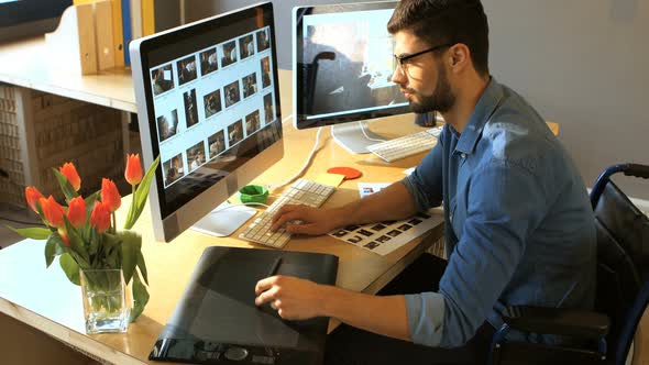 Male graphic designer working on computer