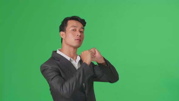 The Smiling Asian Business Man Dancing Sides While Standing On Green Screen In A Green Screen Studio