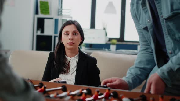 Portrait of Businesswoman Looking at Foosball Game Table