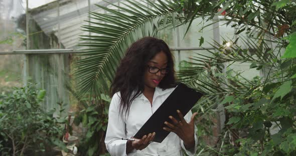 Biologist or Scientist African American Woman Working in a Botanical Garden