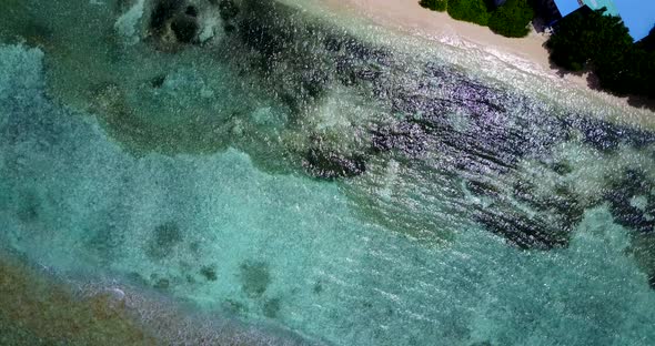 Luxury above island view of a sunshine white sandy paradise beach and aqua blue water background in 