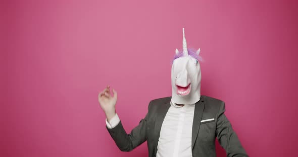 Man with Unicorn Mask Making Funny Gestures