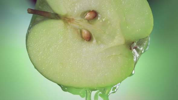 Flowing Green Apple Juice From Half Apple  Macro Shot in Slow Motion
