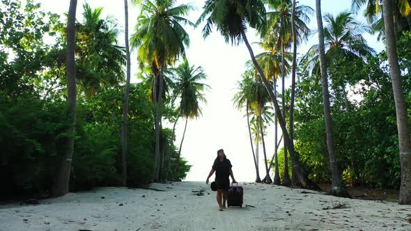 Modern fun woman relaxing spending quality time on beach on clean white sand and blue background 4K