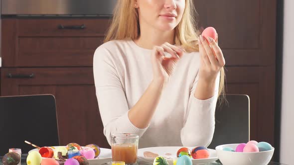 Mother Decorating Easter Eggs for Holiday