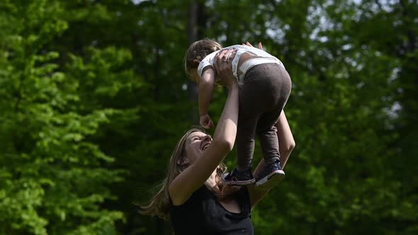 Slow Motion Of Happy Young Mother Playing With Her Toddler Daughter