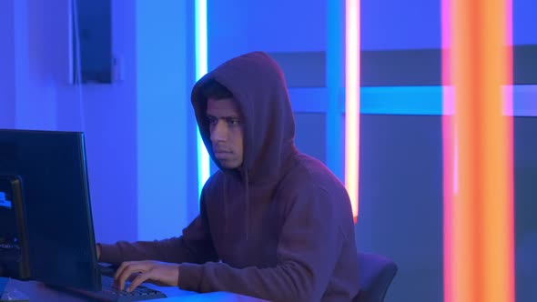 African Hacker Dressed in Hoodie Working on the Computer