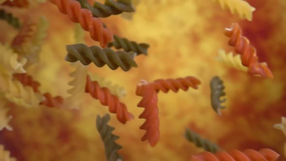 Closeup of the Pasta Fusilli Falling Diagonally on a Yellow Ochre Background