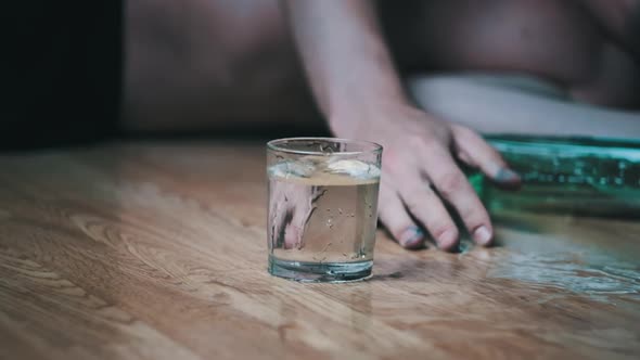 Slow Motion Alcoholic Falls to the Floor with Spilled Glass of Alcohol Overdose