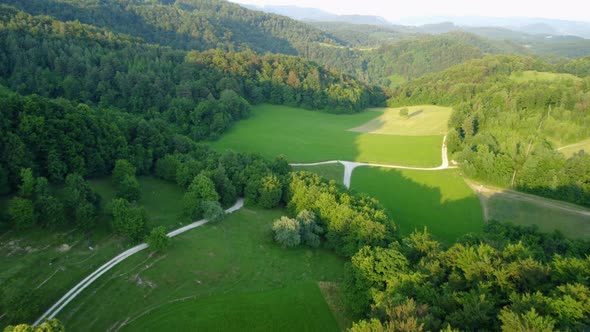 Wonderful green meadows high in Slovenian hills. Great hiking and biking destination. Aerial 4k view