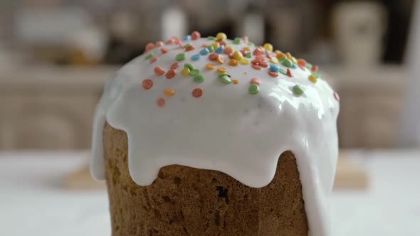 Preparing Easter cakes. Decoration sweet sugar icing sprinkled with colorful be. Happy Easter