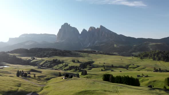 Flying backwards above blooming fields meadows at Alpe di Suisi  in Dolomites Italy