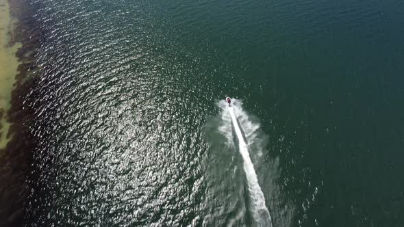 Aerial View of a Scooter at the Lake Surface