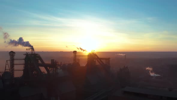 Aerial Forward Cityscape Sunset Factory Chimney Smoke Building Steam Thermal Power Plant. Factory