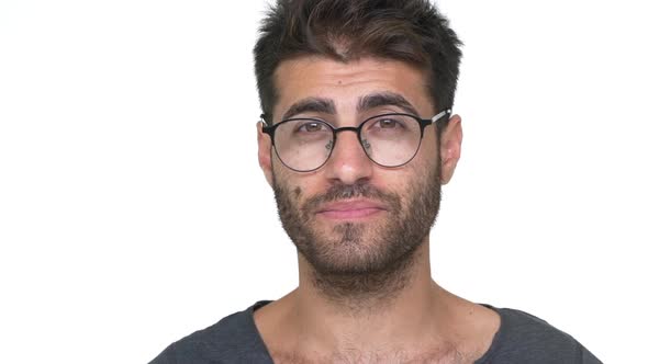 Hispanic Bearded Guy in Glasses with Brilliant Smile Looking on Camera Feeling Pleased Over White