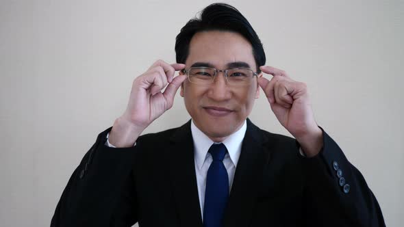 businessman facing camera. wearing glasses.