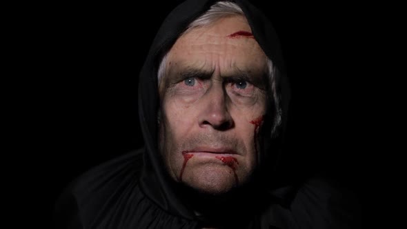 Old Executioner Halloween Makeup and Costume. Elderly Man with Blood on His Face