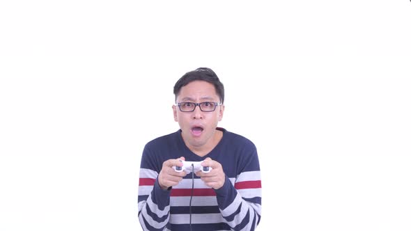 Face of Happy Japanese Hipster Man with Eyeglasses Playing Games