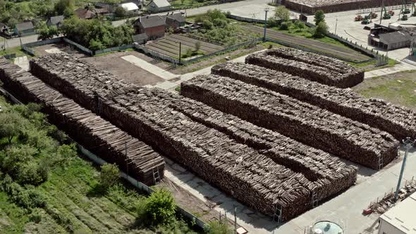 Aerial View Flying Over Warehouse of Trees at a Logging Production