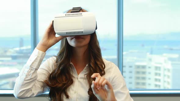 Female executive using virtual reality headset