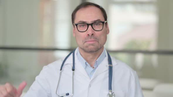 Middle Aged Doctor Showing Thumbs Down Sign