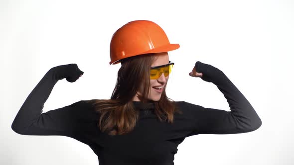 Worker contractor woman. Young woman showing her muscularity.
