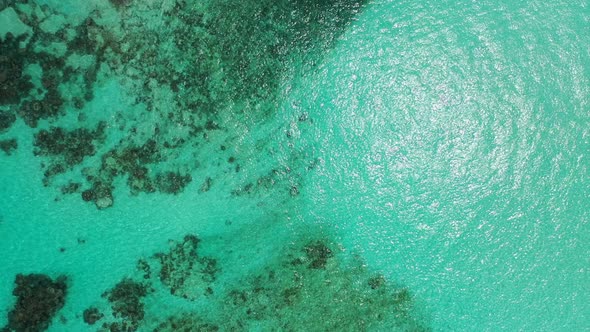 Wide angle aerial abstract shot of a paradise sunny white sand beach and blue water background in co