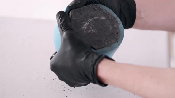 Closeup of Process of Making Pot Using Blue Stencil