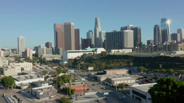 AERIAL: Flying Away From Downtown Los Angeles, California Skyline at Beautiful Blue Sky and Sunny