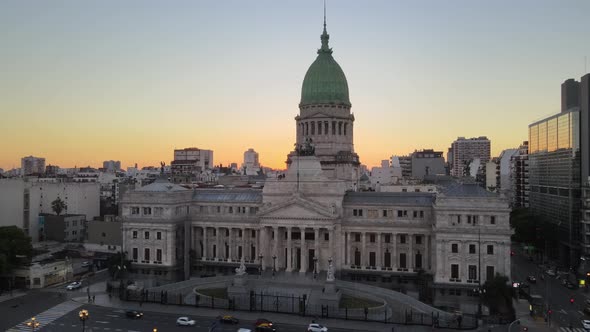 Aerial rising over Argentine Congress Palace with Balvanera buildings in background at golden hour i