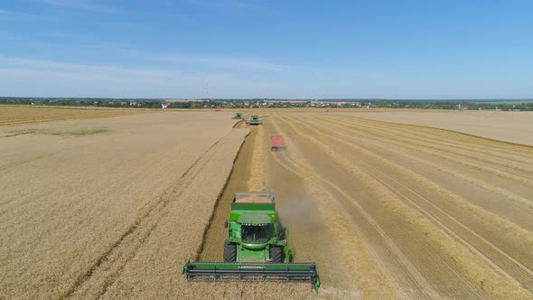 Combine Harvester on Wheat Field