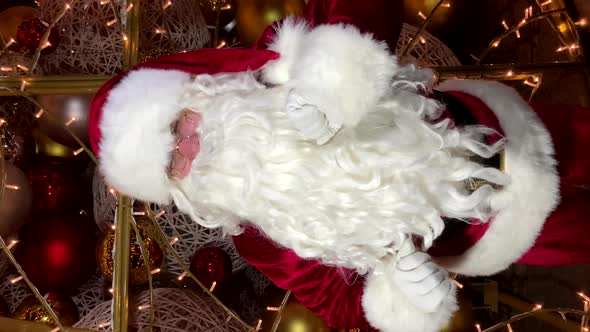 Funny Santa Claus is Talking to the Camera Wishing Merry Christmas and Happy New Year