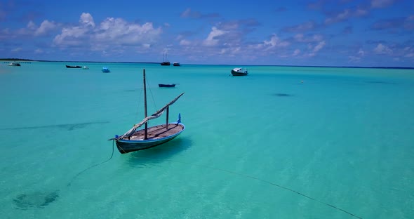 Beautiful above copy space shot of a sandy white paradise beach and blue ocean background in colorfu