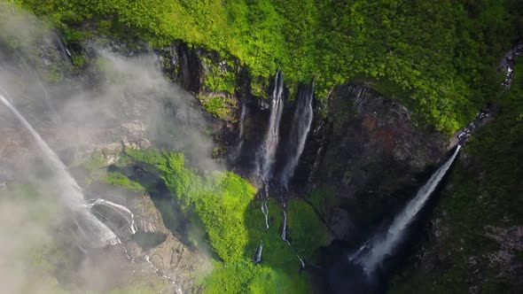 Aerial view above waterfall surrounding by jungle, Faroe Island.