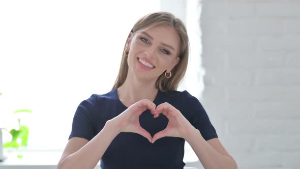 Loving Woman Showing Heart Shape By Hands