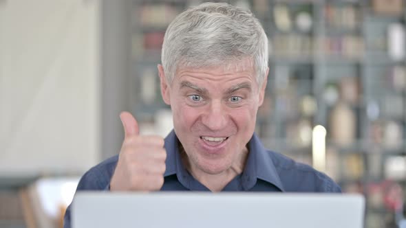 Portrait of Successful Man Celebrating with Fist While Working on Laptop