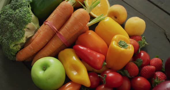 Video of fresh apples, carrots, peppers and tomatoes on black background