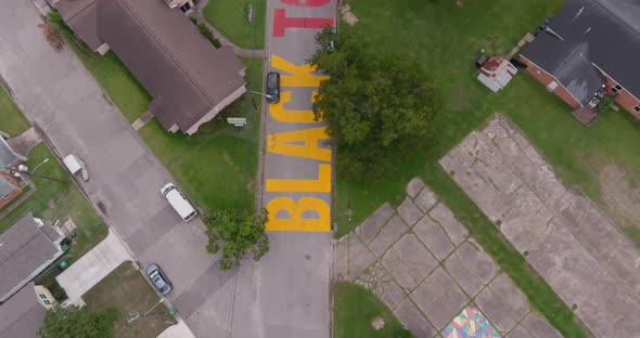 Bird eye view of a large "Black Towns Matter" sign painted on street in Houston Historical independe