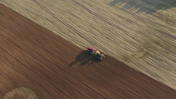 Tractor Planting Seeds Of Grain Crops In Agricultural Field Aerial Top View