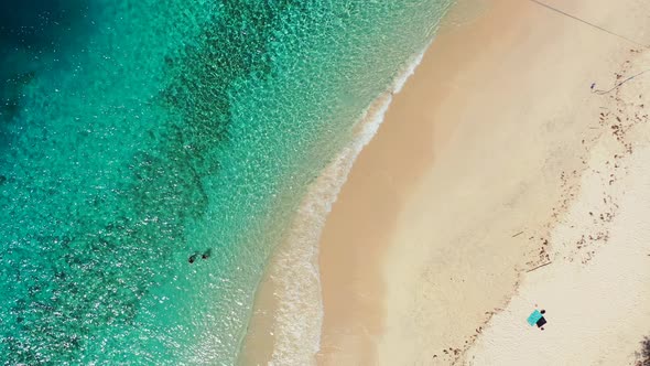 Beautiful aerial island view of a paradise sunny white sand beach and aqua blue water background in 
