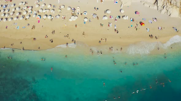 Aerial Top View on Famous Kaputas Beach Blue Sea Umbrellas and Tourists in Kas Turkey