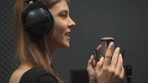 Joyful Lady Vocalist with Headphones Sings Positive Song